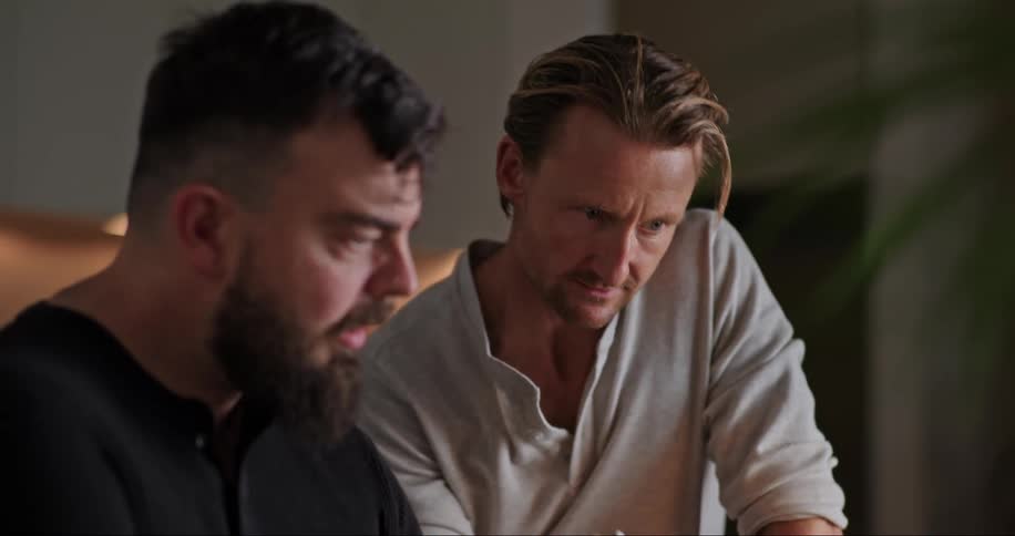 Portrait of two men having a conversation in an indoor setting