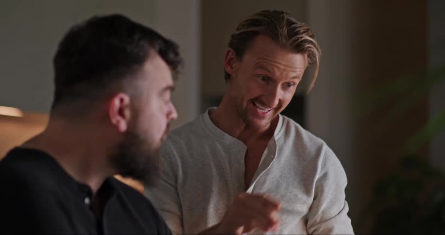 Portrait of two men conversing with one of them pointing at something