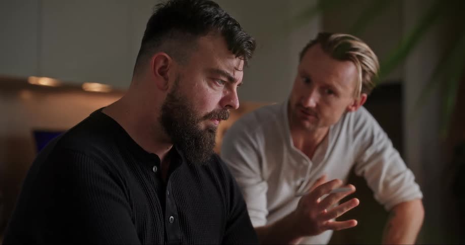 Two men talking and working at home