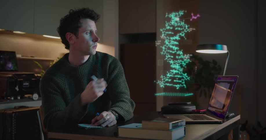 A man looks at a hologram and takes notes