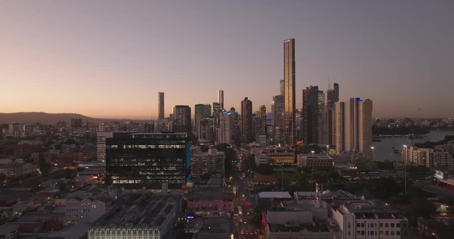 Aerial of buildings and skyscrapers in a metropolitan area at sunset