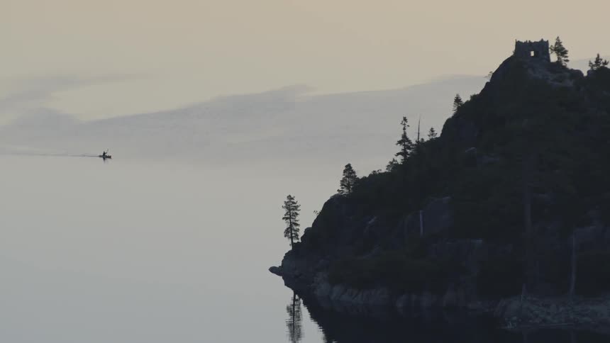 A large lake has a cliff on the side