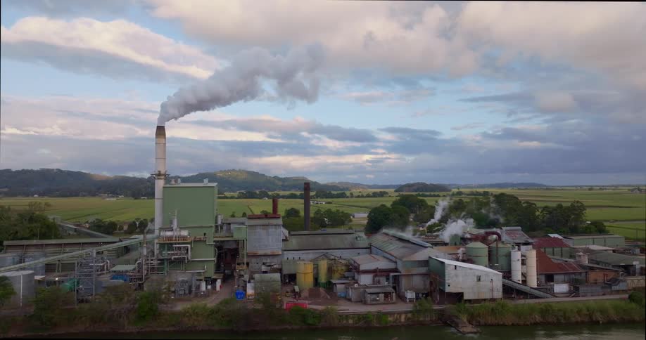The factory is by the farm land