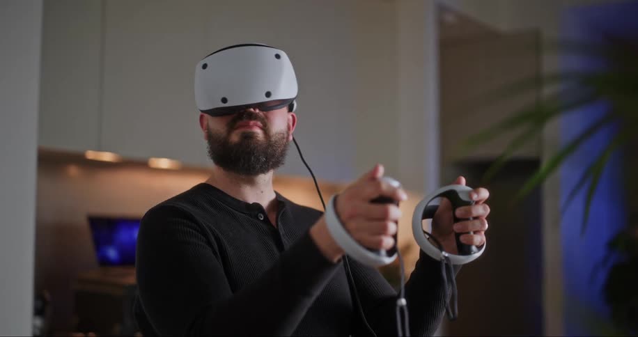 A man smiling with a virtual reality set strapped to his head