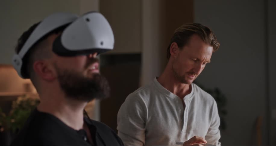 Two people testing virtual reality goggles at the office