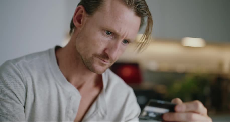 Man checks the balance of his credit card at home