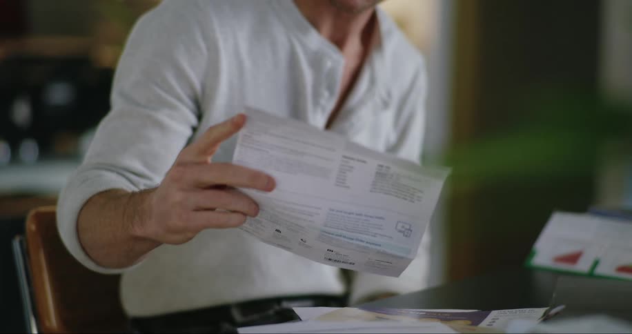 A man examines a piece of paper