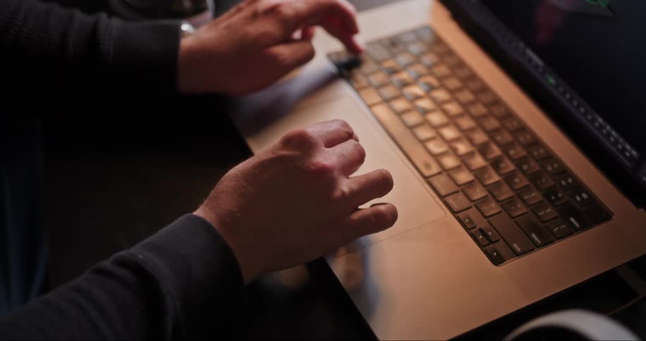 A designer works on a 3d model in a laptop