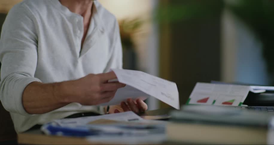 Man checks the mail in front of his laptop