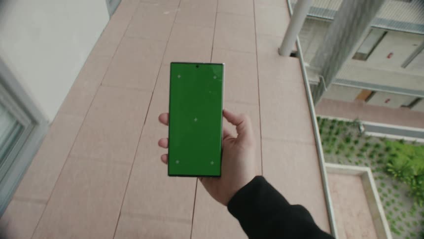 A person walks by the doors of the building outside