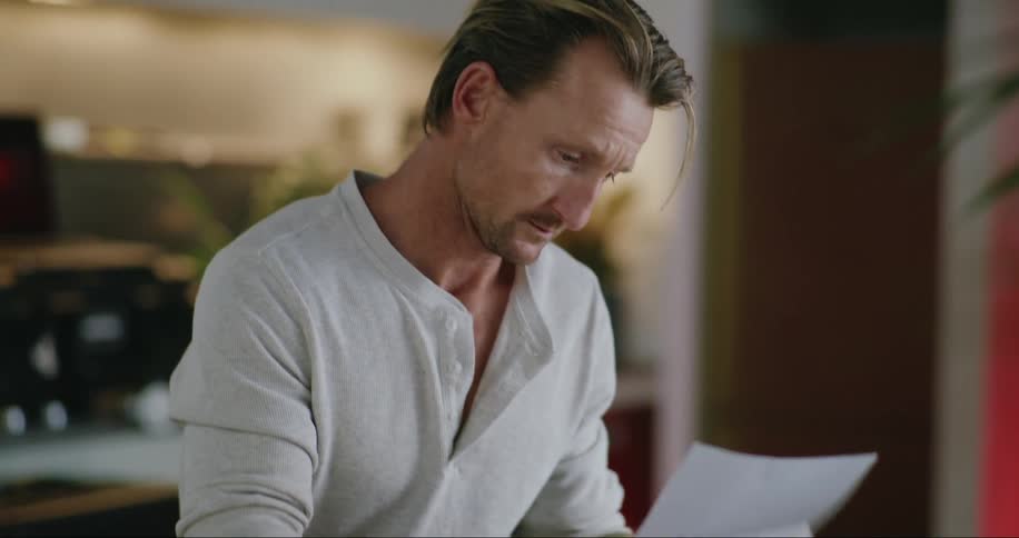 A man opens and reads his mail
