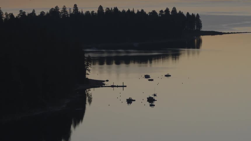 The water is very calm in this lake at dawn