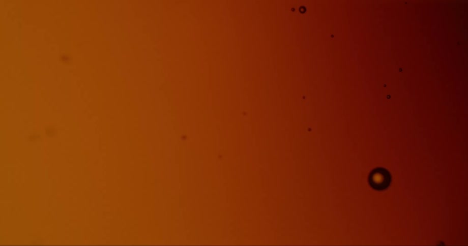 Liquid with small floating bubbles roils briefly
