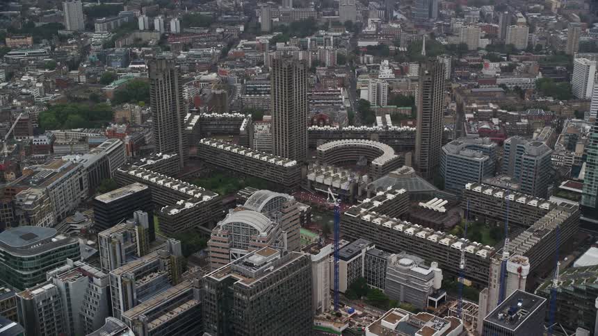Taller city buildings tower over multiple buildings with similar architectural details
