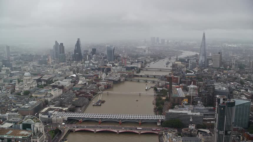 Aerial of buildings and bridges with moving cars in a metropolis