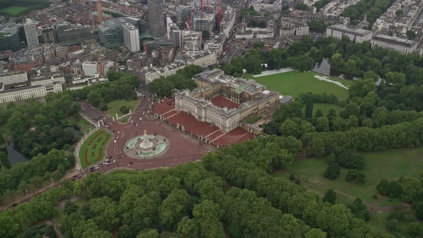 A cityscape featuring residential buildings surrounded by lush green vegetation and trees lining the streets enhancing the natural beauty of the urban environment