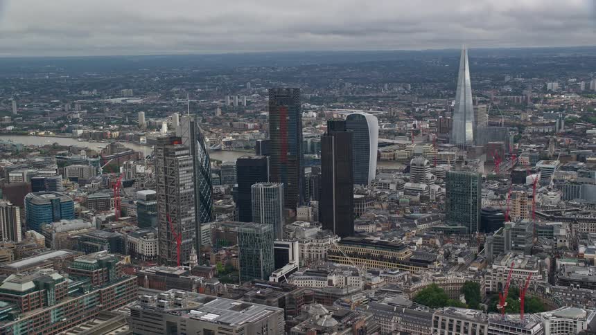 A city with several huge buildings and a huge monument behind
