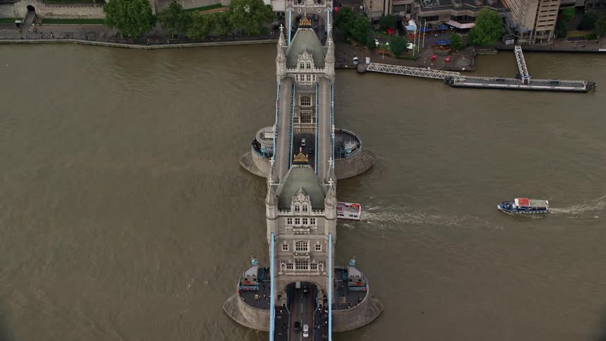 Aerial view of a bridge over the lake with vehicles passing and small boats navigating on the lake