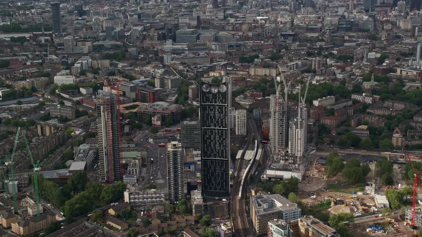 Aerial view of a metropolis with tall towers a train and vehicles