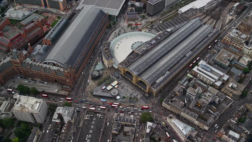 Aerial view of a train station in the midst of the city