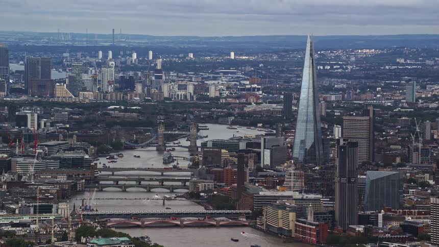 The monument the shard in london city with a river and several bridges crossing over it