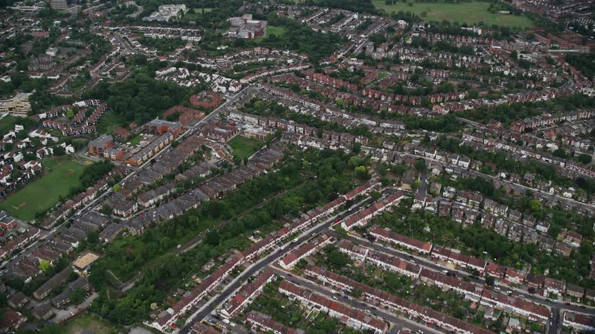 Aerial view of a residential area with extensive green tree plantations