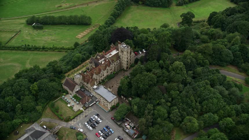 A large old residential structure in the middle of the forest