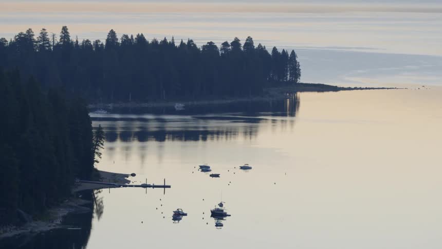 The water is calm in this lake surrounded by trees