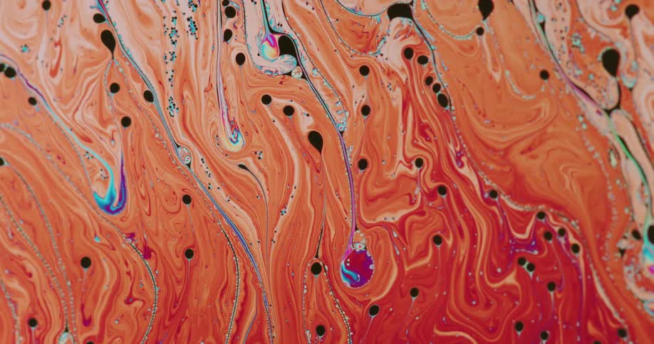 Bright colorful liquid ink flows forming abstract shapes