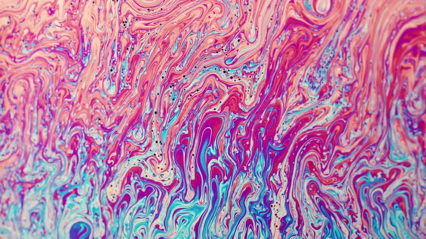 Liquid moves and fluorescent stripes bend and mix as they twist and stretch