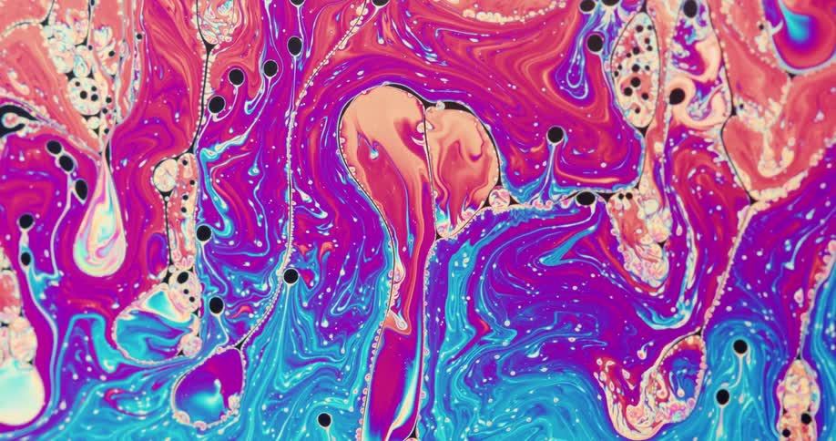 Bright colorful liquid ink moves forming abstract psychedelic shapes