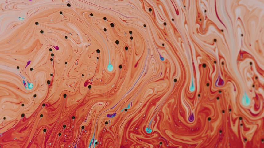 Colored liquid with small dots of purple colors