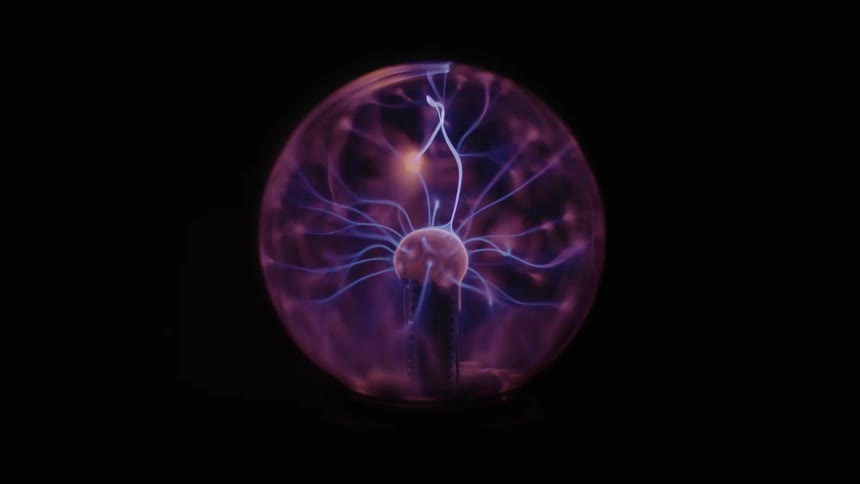 A glass ball with a tesla coil shocks the glass