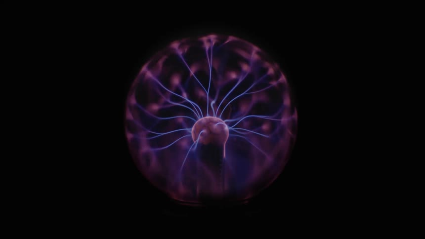 Blue bolts play about interior of plasma ball against a reddish background