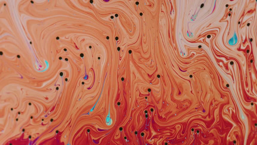 Bright colorful liquid ink flows forming abstract shapes