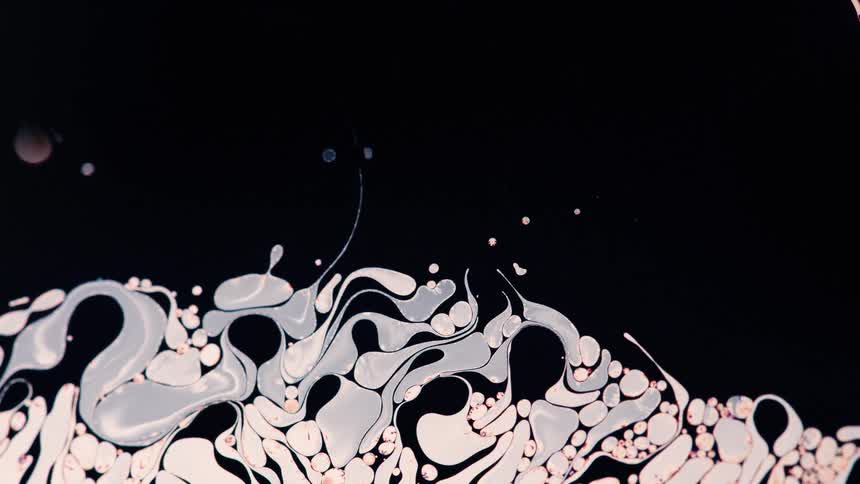 Abstract colorful liquid in motion against dark background