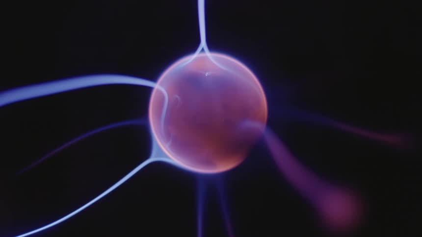 A sphere with orange and purple strings striking its surface