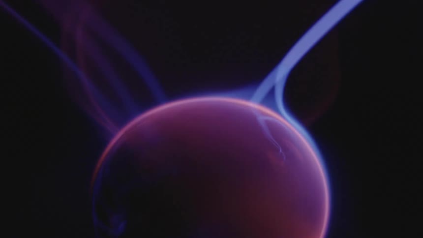 Glowing blue electric appendages extend and from a luminous pink globe as they move in the darkness