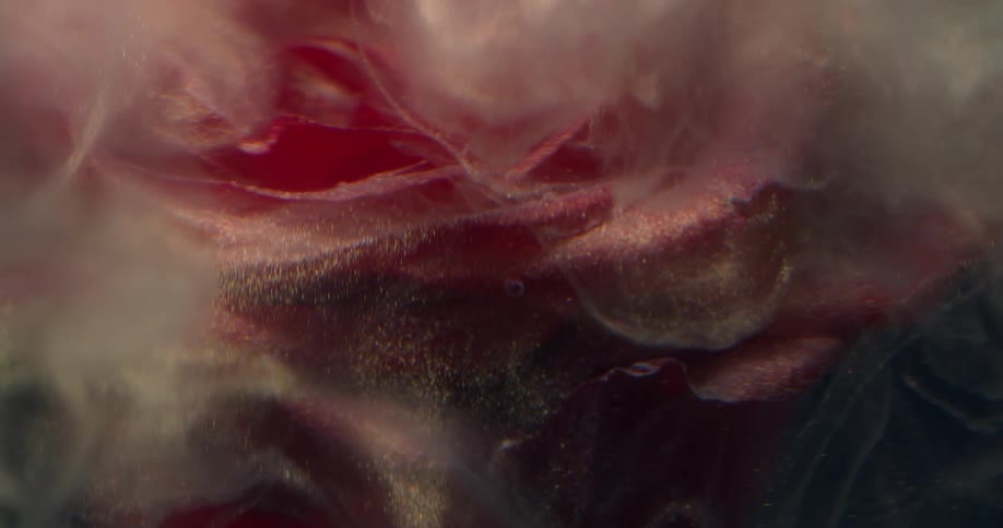 A bright red environment with particles and smoke falling in liquid form