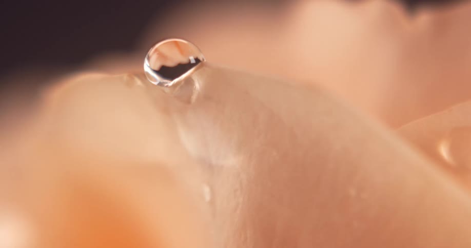 Water drops on the skin of a person and falls off