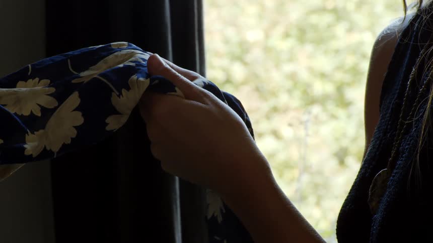 Woman hands running over a light blue fabric