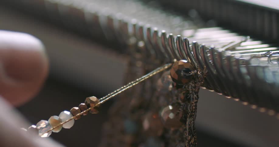 A person is making jewelry