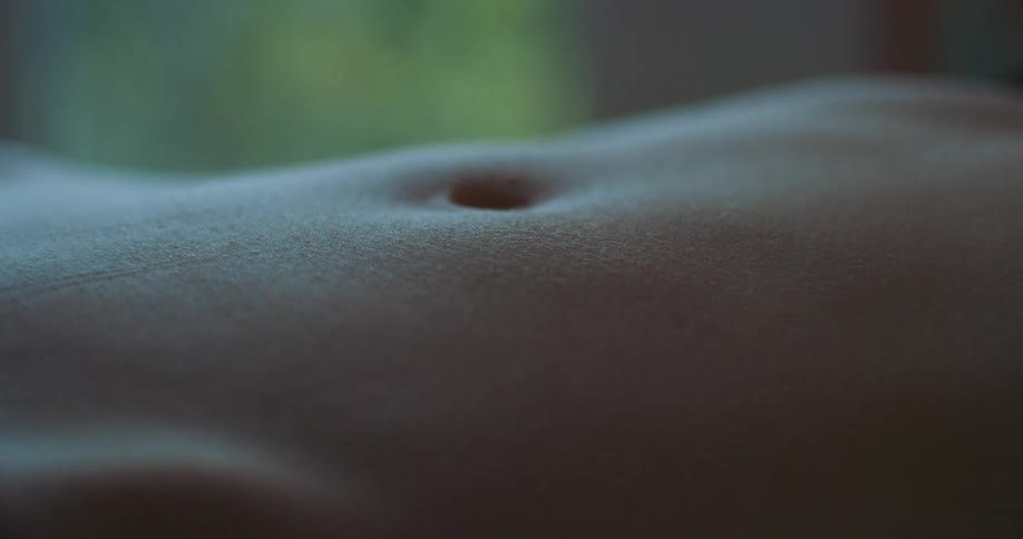 Mans stomach muscles flex as he breaths