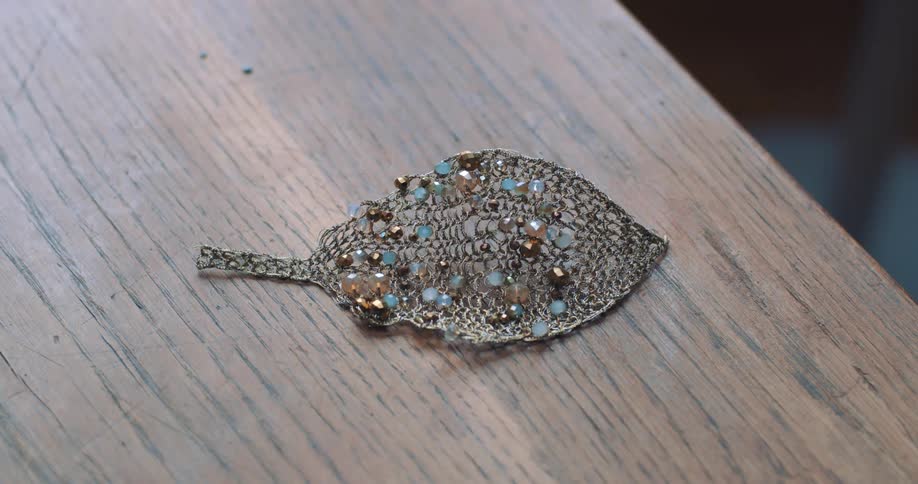 Close up of brooch pin on table