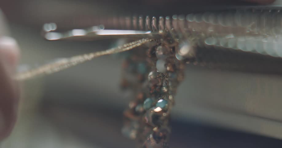 A person is making jewelry