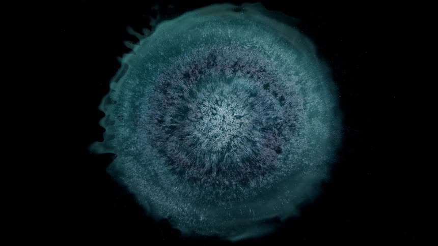 Blue mixture spreads from tight white glowing core against blackness