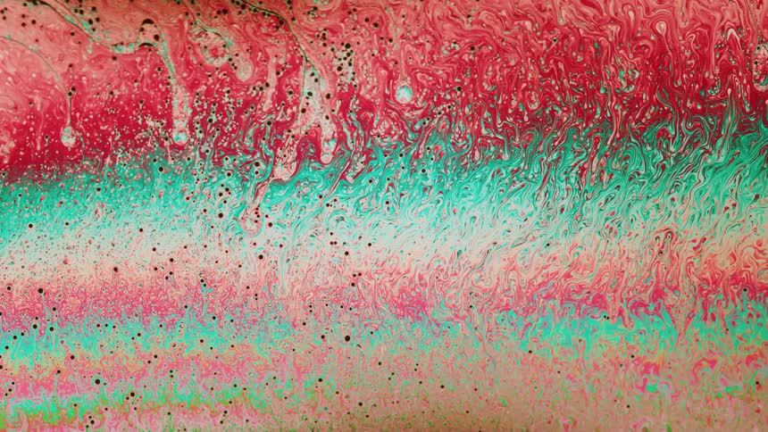 Teal and reddish pink abstract liquid ripples