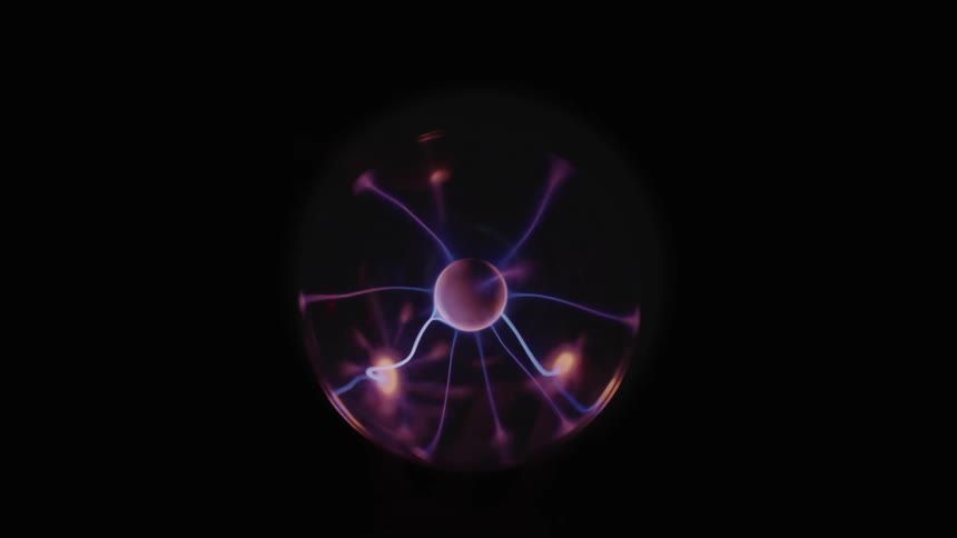 Static bolts play about interior of plasma ball in dark area
