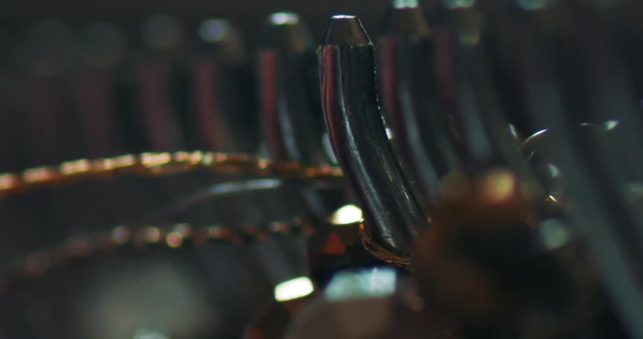 A golden thread being pulled by an iron hook