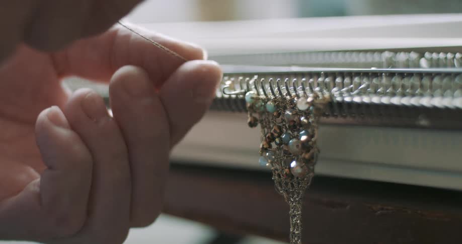 Hands creating a gold jewelry